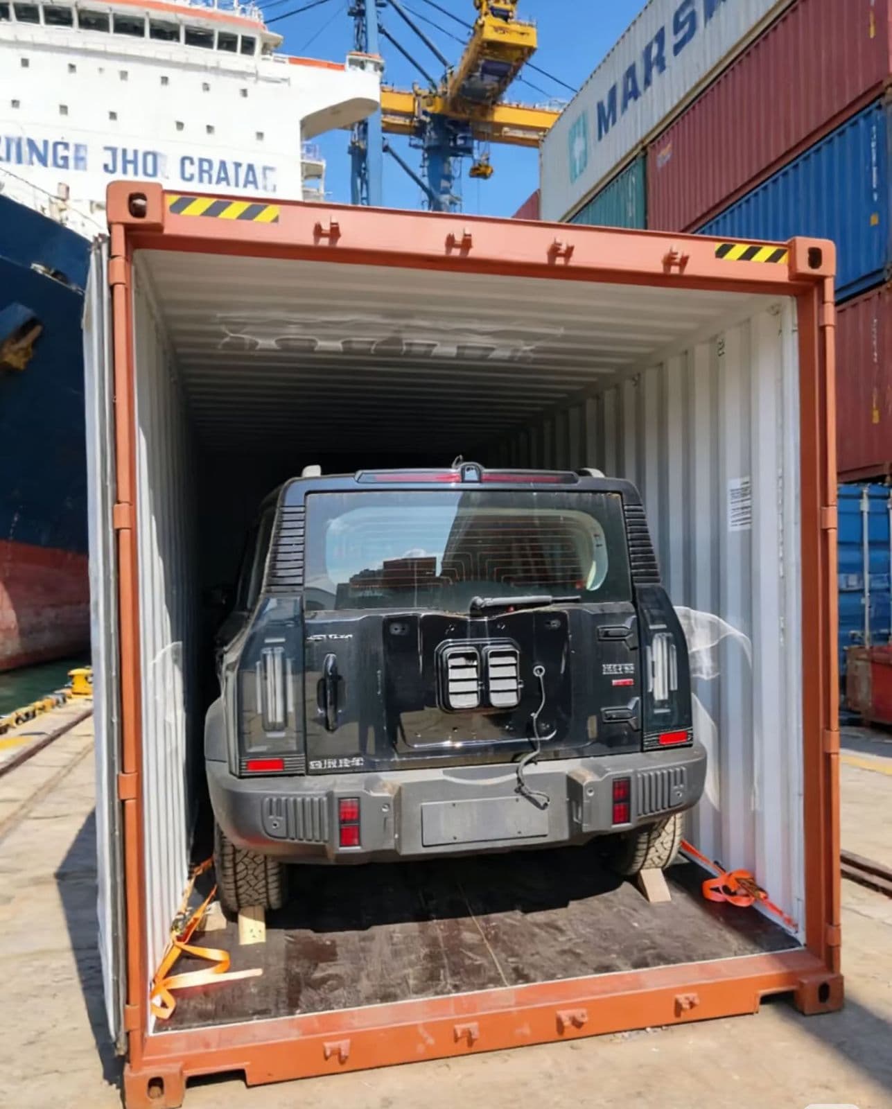 Vehicle lashed inside a container at the port